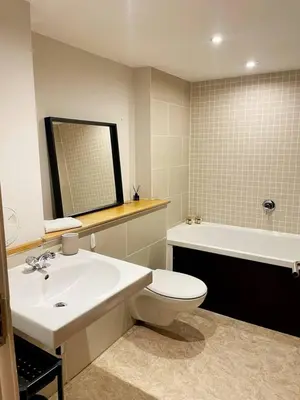 a bathroom with a sink and a toilet and a tub at SEC Hydro Duplex in Finnieston in Glasgow