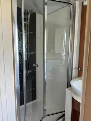 a glass shower in a bathroom with a sink at Aspen Scenic 53 in Ardentinny