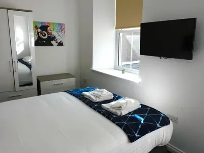 a bedroom with a bed with towels on it at No 1 - 2 bedroom apartment in Lanark Town Centre in Lanark