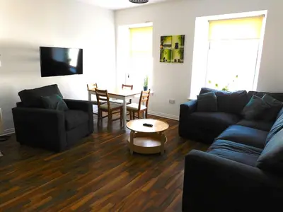 a living room with a couch and a table at No 1 - 2 bedroom apartment in Lanark Town Centre in Lanark