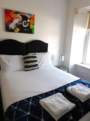 a bedroom with a bed with two towels on it at No 1 - 2 bedroom apartment in Lanark Town Centre in Lanark