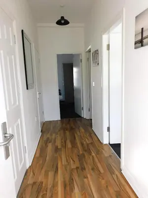 an empty hallway with wooden floors in an apartment at No 1 - 2 bedroom apartment in Lanark Town Centre in Lanark