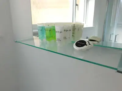 a glass counter top with some products on it at No 3 - Modern Studio Apartment in Lanark Town Centre in Lanark