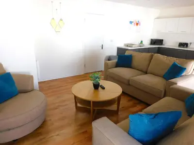 a living room with two couches and a table at No 5 - Modern 2 bedroom Apartment in Lanark Town Centre in Lanark