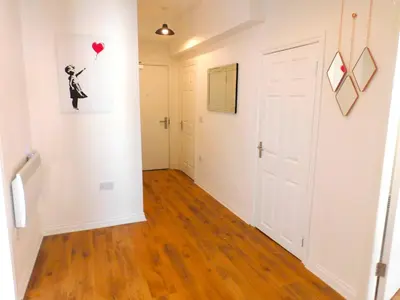 a hallway with a room with a heart balloon on the wall at No 9 - Modern 3 Bedroom Apartment in Lanark Town Centre in Lanark