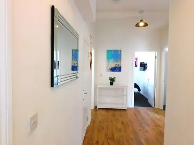 a room with a hallway with a mirror on the wall at No 9 - Modern 3 Bedroom Apartment in Lanark Town Centre in Lanark