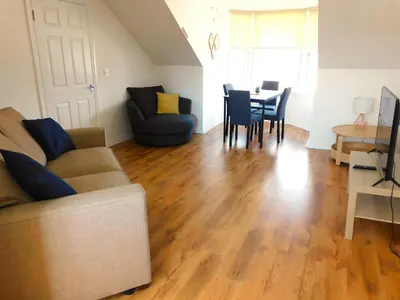 a living room with a couch and a table at No 11 - Contemporary 2 Bedroom Apartment in Lanark Town Centre in Lanark