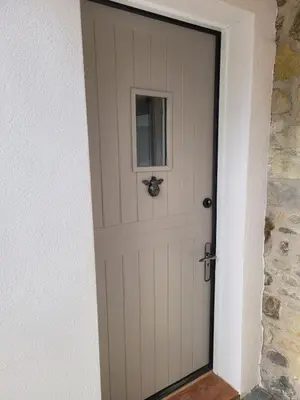 a door with a spider sitting on top of it at Hot Tub Cottage in Ayrshire in Stewarton
