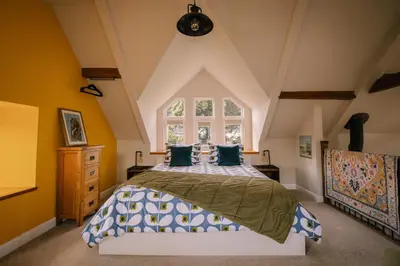 a bedroom with a bed and a window at Stunning Barn Conversion in Dunlop