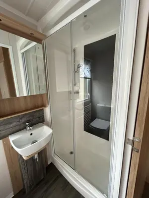 a bathroom with a sink and a shower at Swift Bordeaux Sea View 10 in Ardentinny