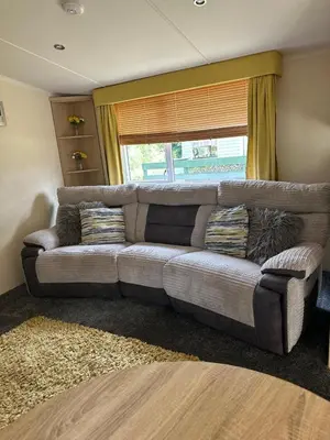 a couch in a living room with a window at Swift Serenity 50 in Ardentinny