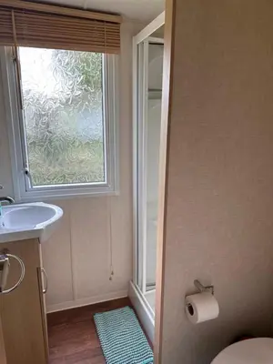 a small bathroom with a sink and a window at Swift Serenity 50 in Ardentinny