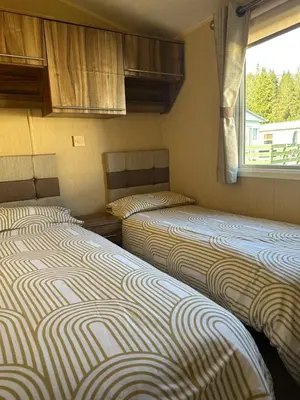 two beds in a small room with a window at Winchester 23 in Ardentinny