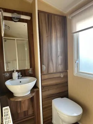 a bathroom with a white sink and a toilet at Winchester 23 in Ardentinny