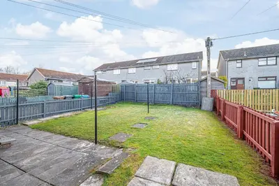 a backyard with a fence and a yard with a yard at Pure Home Oakley Park View by TBA in Dunfermline
