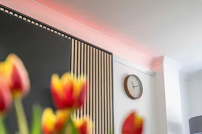a clock on the side of a wall with flowers at Super Prime Luxury 4 Bedroom Detached Home by TBA in Fife