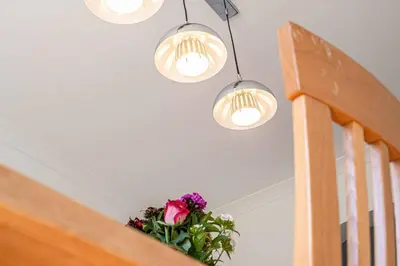 a pot of flowers sitting on a staircase with lights at Super Prime Luxury 4 Bedroom Detached Home by TBA in Fife