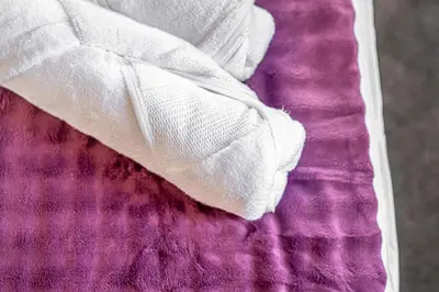 a white glove sitting on top of a purple blanket at Super Prime Luxury 4 Bedroom Detached Home by TBA in Fife