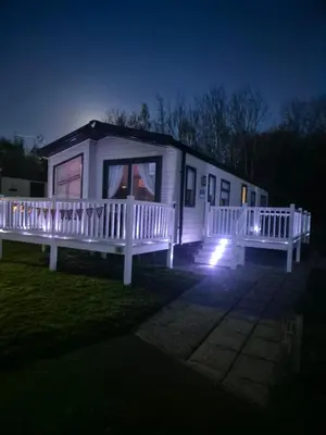 a small white house with a porch at night at 2 bedroom platinum in Minishant