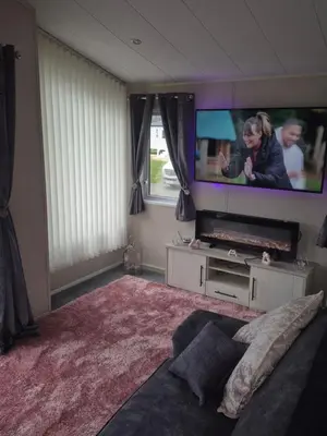 a living room with a tv and a couch at 2 bedroom platinum in Minishant