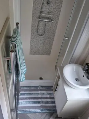 a bathroom with a sink and a shower and a staircase at 2 bedroom platinum in Minishant