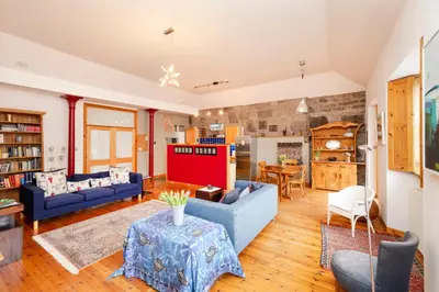 a living room with blue couches and a table at Edinburgh New Town Deluxe Apartment with Terrace in Edinburgh