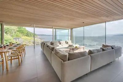 a living room with a large couch and tables and windows at 4 Bed in Cove oc-r31840 in Cove
