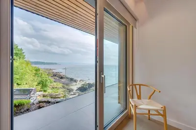 a window with a chair and a view of the ocean at 4 Bed in Cove oc-r31840 in Cove