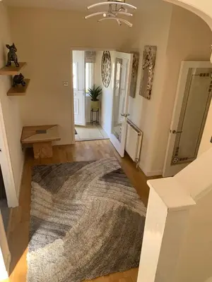 a living room with a rug on the floor at The Old High Road, North Ayrshire in Stevenston