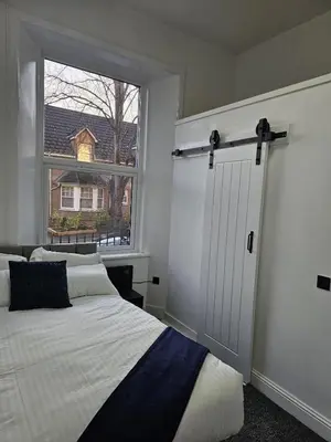 a bedroom with a white bed and a window at Central Hotel Edinburgh in Edinburgh