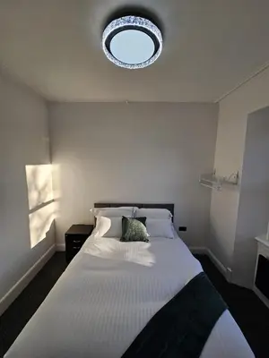 a bedroom with a large white bed with a window at Central Hotel Edinburgh in Edinburgh