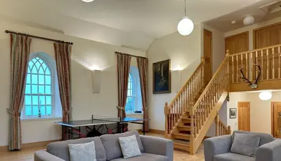 a living room with a couch and a table at Leargy House in Isle of Jura