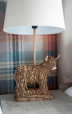 a lamp with a statue of a dog on a table at The Rise Retreat in Livingston