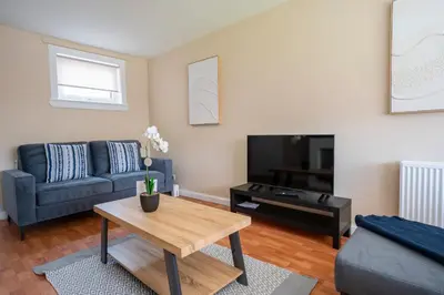 a living room with a couch and a coffee table at Marina House in Bathgate