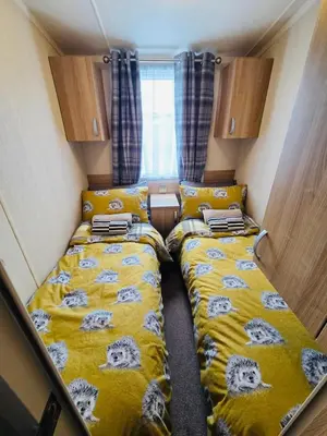 a small room with two beds in a tiny house at The Canny View at Three Lochs Holiday Park in Balminnoch 3 bedroom sleeps upto 8 guests in Newton Stewart