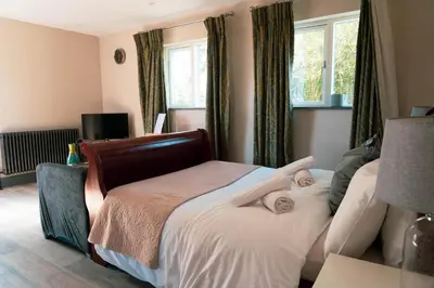 a bedroom with a bed with two towels on it at The Snook-Free Parking-Near Pentland Hills in Loanhead