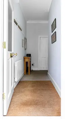 an empty room with a table and a door at Coastal Charm in Kingarth
