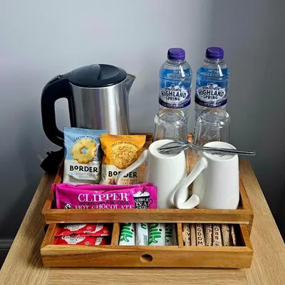 a wooden tray with food and drinks on a table at Glenroy Guest House in Oban