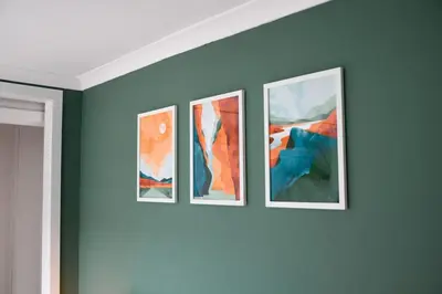 four framed paintings on a wall in a room at Homely 2 Bed House with Private double driveway in Oban