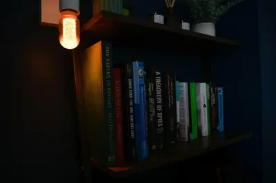 a book shelf with a bunch of books on it at Homely 2 Bed House with Private double driveway in Oban