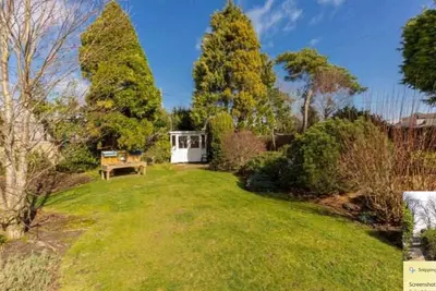 a garden with a bench in the middle of a yard at Amulree, Edinburgh City in EDI