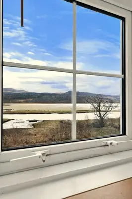 a window with a view of a field at Finest Retreats - Lochead Cottage in Achahoish