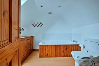 a bathroom with a white toilet and a sink at Finest Retreats - Lochead Cottage in Achahoish
