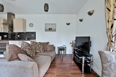 a living room with a couch and a tv at Finest Retreats - The Turbine House in Achahoish