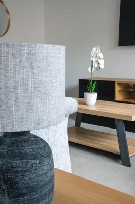 a living room with a chair and a table at Stirling Street Stays in Tillicoultry