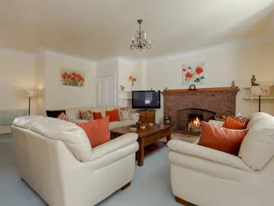 a living room with two chairs and a fireplace at Holiday Home Balcraig House by Interhome in Straiton