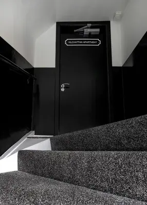 a black door with a sign on it next to some stairs at Castle Street Apartments - Luxury Kilchattan Apartment in Rothesay
