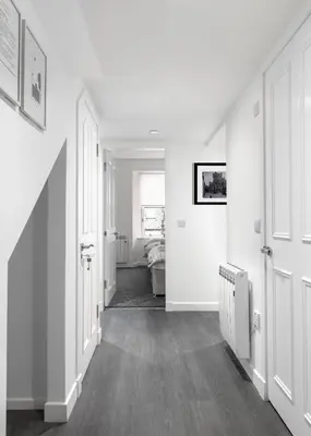 a hallway with white walls and white doors at Castle Street Apartments - Luxury Kilchattan Apartment in Rothesay