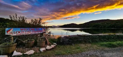 a sign in front of a body of water at Castle Street Apartments - Luxury Kilchattan Apartment in Rothesay