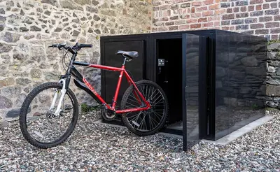 a red bike parked next to a building at Castle Street Apartments - Luxury Scalpsie Apartment in Rothesay